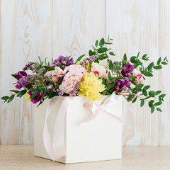 fresh flowers in box on a wooden background. Copyspace