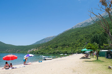 Fototapeta na wymiar Holidaymakers at Ljubanishta Beach on the shores of Lake Ohrid, Republic of Macedonia