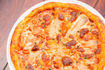 Salmon pizza on a wooden table