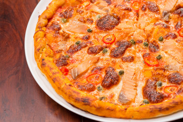 Salmon pizza on a wooden table