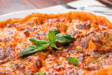 Italian pizza with mozzarella, tomato and basil