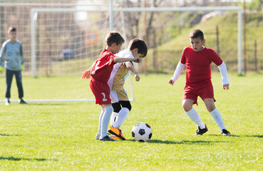 Obraz premium Kids soccer football - children players match on soccer field