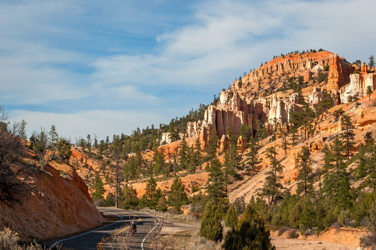 A motorcycle driving on a road through the picturesque scenery in the vicinity of Water Canyon
