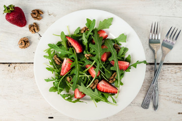 Fresh salad with arugula and strawberries