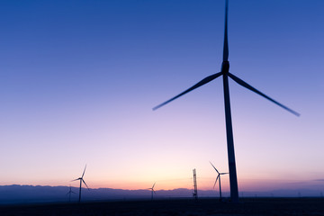Fototapeta premium wind turbines in field at twilight