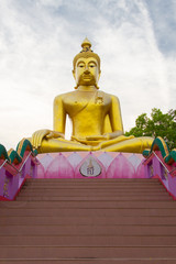 Big Golden Buddha statue over scenic white and blue sky  at Wat Sai Dong Yang Temple. Phichit, Thailand.