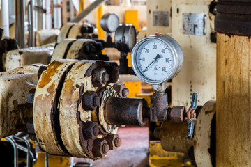 Closeup of pressure gauge , pressure gauge measuring gas pressure. Pipes and valves at oil and gas industrial plant.