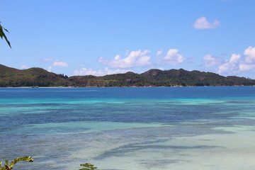 Anse Takamaka, Praslin Island, Seychelles, Indian Ocean, Africa / View to Curieuse Island. 