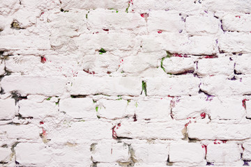 Old brick wall painted in white, urban background