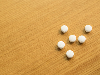 Silver aluminium blister White pill pharmacy medicine health care, medication on wooden background