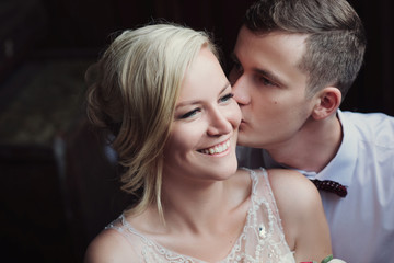 Wedding couple is hugging each other. Man in suit. Beauty bride with groom. Female and male portrait.Wedding couple in love, close-up portrait of young and happy bride and groom