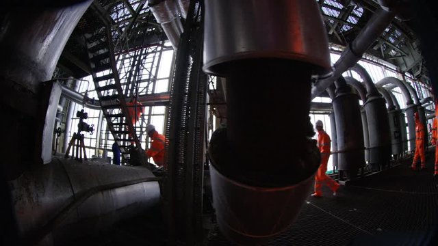 4K Distorted view of engineers at work in industrial plant