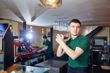 Barman barista throws glass for a cocktail at the bar.