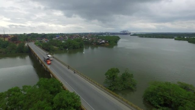 aerial footage of cars passing over a bridge in the afternoon