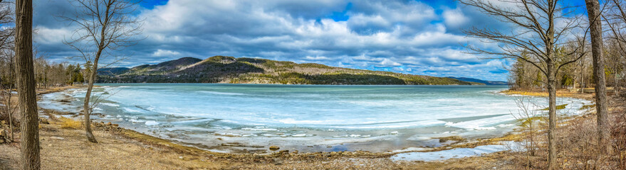 Winter panoramic view with ice on water
