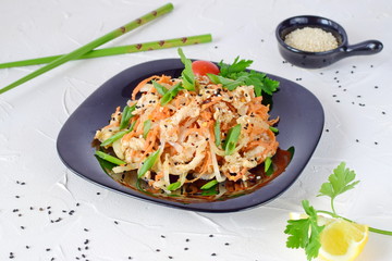 Korean traditional food. Raw chicken marinated with vegetables on a black plate on a white abstract background. easy cooking. Healthy food.