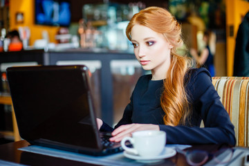 Female student preparing for exam in cafe