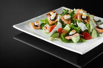 sushi in a white plate on a dark  background with reflection