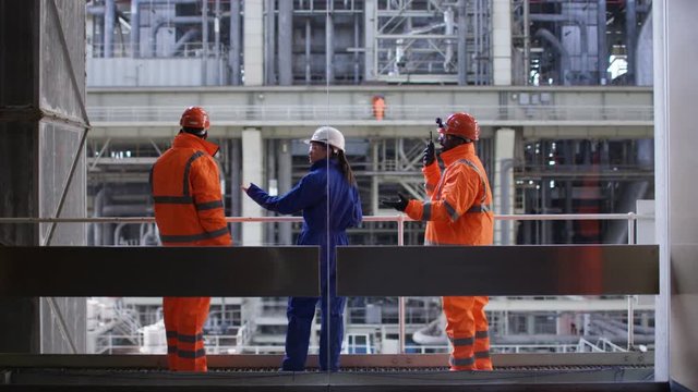  Male & female engineers conducting checks at power station