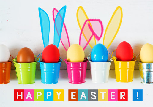 Easter eggs with Rabbit ears in colored buckets on white, selective focus image, Card Happy Easter 