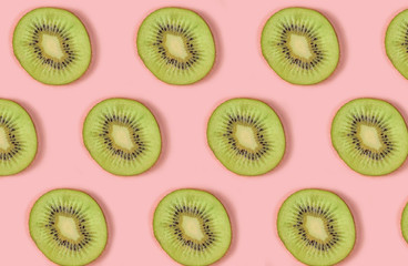 Pattern of kiwi Fruits on pink Background, similar slices