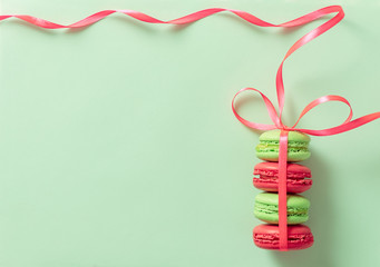 Macaroons or macaroni tied by ribbon on retro style pop art background. Free space for text