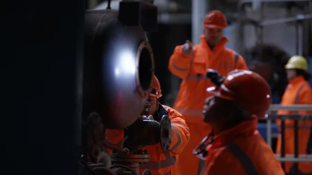  Engineers in power station carrying out maintenance & checking the machinery