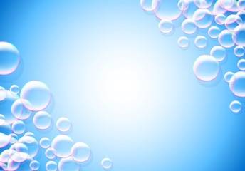 Soap bubbles abstract blue background with rainbow colored airy foam