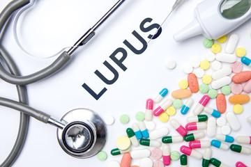 Lupus word with drugs and stethoscope