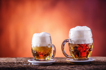 Beer. Two cold beers. Draft beer. Draft ale. Golden beer. Golden ale. Two gold beer with froth on top. Draft cold beer in glass jars in home pub hotel or restaurant. Empty beer glass. Still life.