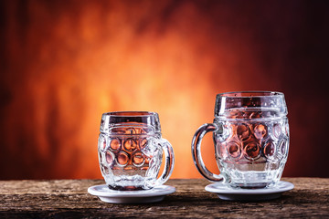 Beer. Two cold beers. Draft beer. Draft ale. Golden beer. Golden ale. Two gold beer with froth on top. Draft cold beer in glass jars in home pub hotel or restaurant. Empty beer glass. Still life.