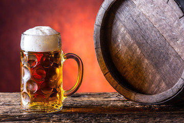 Beer with oak barrel. Draft beer. Draft ale. Golden beer. Golden ale. Two gold beer with froth on top. Draft cold beer in glass jars in home pub hotel or restaurant.