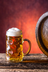 Beer with oak barrel. Draft beer. Draft ale. Golden beer. Golden ale. Two gold beer with froth on top. Draft cold beer in glass jars in home pub hotel or restaurant.