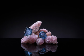 Beautiful sapphires with rose quartz on dark background