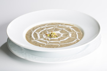 Vegetable green cream soup with sour cream