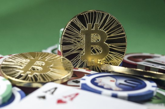 Bitcoin coins with poker cards and chips