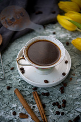 Black coffee on a table with flowers
