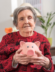 Senior woman with piggy bank