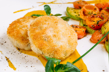 Chicken cutlets, grilled zucchini and fresh vegetable salad