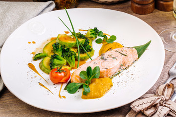 grilled salmon steak on a round white plate