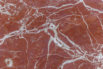 Naklejka premium The texture of the red marble slab on the wall