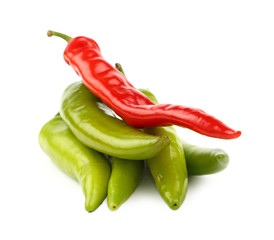 Green and red hot chili peppers close up on white