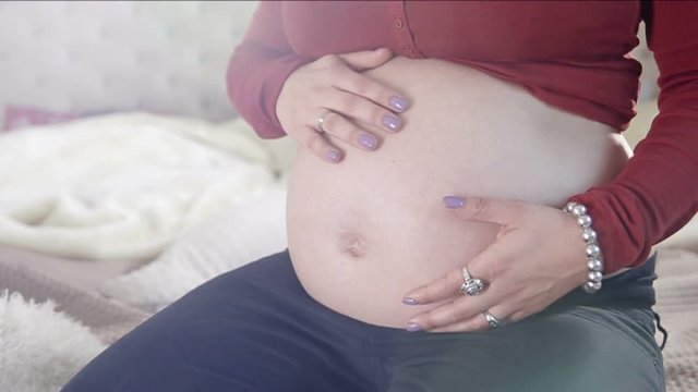 Close up of pregnant belly. FULL HD. SLOW MO