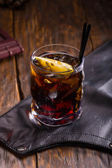 White rum with a piece of a lime and Coca with a glass with ice