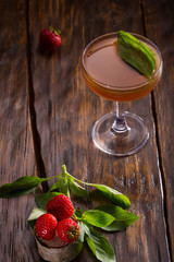 Alcoholic cocktail with vodka, lemon juice, a basil and strawberry