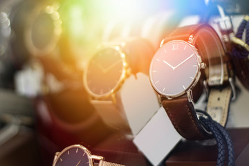 Close up shot of a luxury men watch. Lens flare in background.