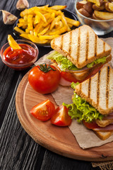club sandwich with Tomato, lettuce, bacon, ham and french fries