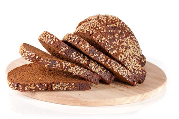 slices of black bread with sesame seeds on a cutting board isolated on white background