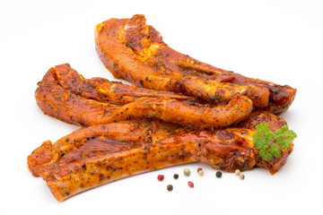 Spicy marinated spare ribs barbecued on the white background.