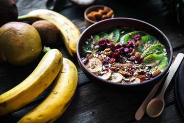Yogurt with different fruits on a wooden background. Useful food, diet, organic.